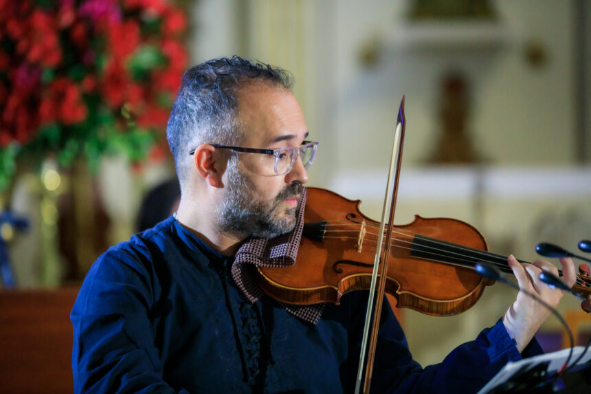2023 premier orchestral institute's composer competition winner Federico Hoyos in close up playing violin.